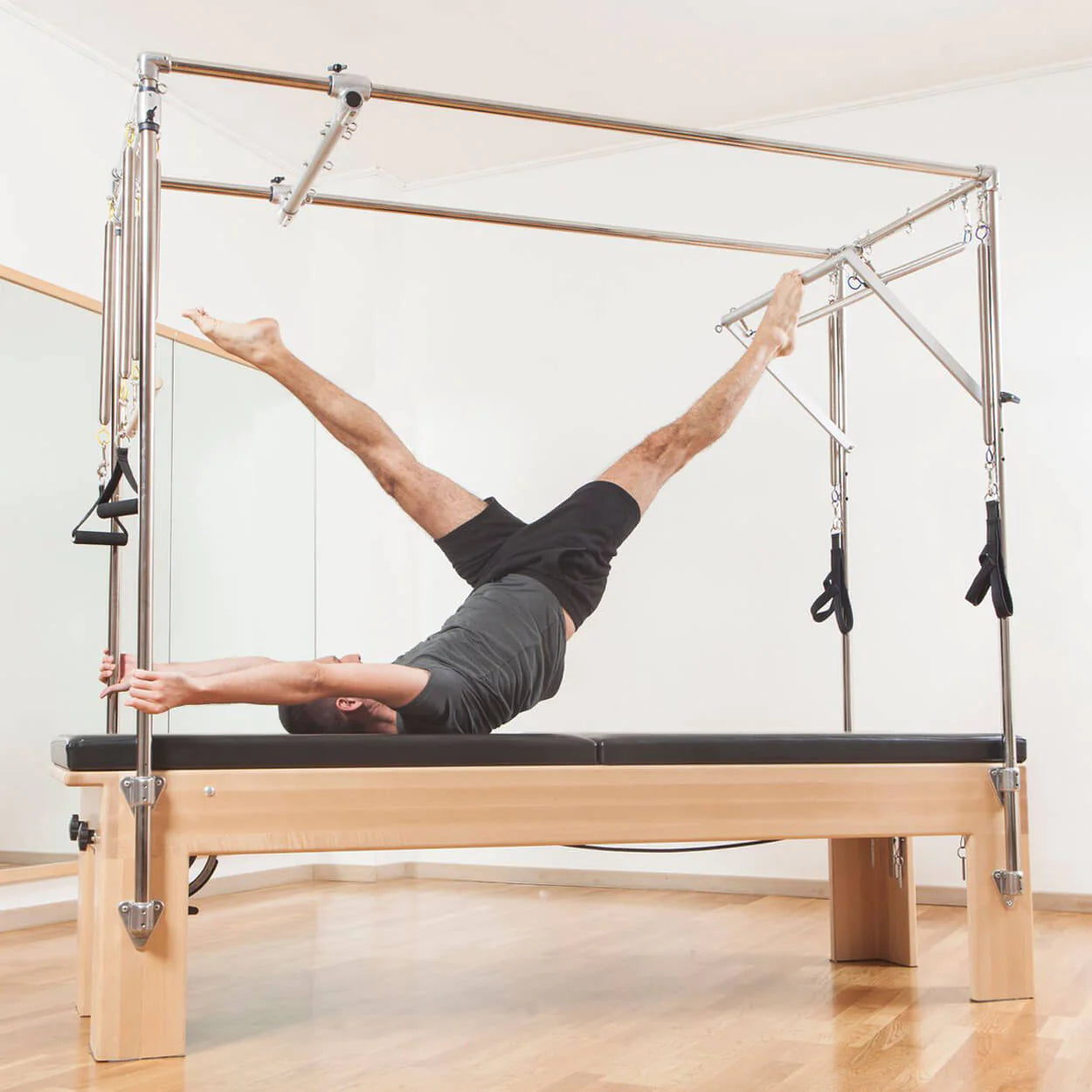 Pilates Cadillac vs. Reformer: What's the Difference?